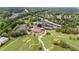 Aerial shot of the community clubhouse, tennis courts, parking, pool, and putting greens with mature trees at 2211 Lattimore Farm Nw Dr, Kennesaw, GA 30152