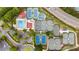 A bird's-eye view showcases a community's pool, clubhouse, and tennis courts surrounded by mature trees and a highway at 2211 Lattimore Farm Nw Dr, Kennesaw, GA 30152