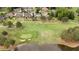 Aerial view of community on a golf course with pond surrounded by lush green fairways and mature trees at 2211 Lattimore Farm Nw Dr, Kennesaw, GA 30152