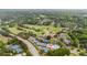Aerial shot featuring a clubhouse, tennis courts, pool, and putting greens surrounded by mature trees and a highway at 2211 Lattimore Farm Nw Dr, Kennesaw, GA 30152