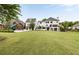 Expansive backyard featuring a lush lawn, playset, and a two-story home with a balcony and outdoor access at 2211 Lattimore Farm Nw Dr, Kennesaw, GA 30152