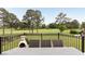 An outdoor living space with a patio overlooking a well-manicured golf course and backyard at 2211 Lattimore Farm Nw Dr, Kennesaw, GA 30152
