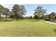 Expansive backyard with a play set, mature trees, and a fence at 2211 Lattimore Farm Nw Dr, Kennesaw, GA 30152