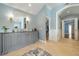 Elegant bathroom with blue walls, dual sinks, walk-in closet, and chandelier lighting at 2211 Lattimore Farm Nw Dr, Kennesaw, GA 30152