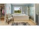 A luxurious bathroom featuring a soaking tub, glass-enclosed shower, and a large window at 2211 Lattimore Farm Nw Dr, Kennesaw, GA 30152