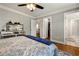 Bedroom featuring hardwood floors, closet, and an open bathroom at 2211 Lattimore Farm Nw Dr, Kennesaw, GA 30152