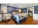 Stylish blue bedroom featuring hardwood floors, chair railing, and a decorative ceiling at 2211 Lattimore Farm Nw Dr, Kennesaw, GA 30152