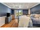Comfortable bedroom with hardwood floors, decorative ceiling, and access to a patio area at 2211 Lattimore Farm Nw Dr, Kennesaw, GA 30152