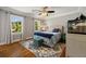 Bedroom featuring hardwood floors, two windows, and a ceiling fan at 2211 Lattimore Farm Nw Dr, Kennesaw, GA 30152