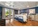 Charming bedroom with blue walls, hardwood floors, and French doors leading to the outdoors at 2211 Lattimore Farm Nw Dr, Kennesaw, GA 30152
