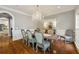 Elegant dining room featuring a rustic wood table, chandelier, and wainscoting detail at 2211 Lattimore Farm Nw Dr, Kennesaw, GA 30152