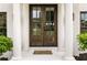 Elegant double doors with glass panes and sidelights, framed by white columns at 2211 Lattimore Farm Nw Dr, Kennesaw, GA 30152