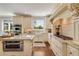 Gourmet kitchen with stainless steel appliances, granite countertops, and custom cabinetry with island cooktop at 2211 Lattimore Farm Nw Dr, Kennesaw, GA 30152