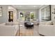 Airy living room featuring white armchairs, and large picture windows that provide natural light at 2211 Lattimore Farm Nw Dr, Kennesaw, GA 30152
