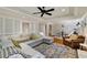 Comfortable living room featuring a large sectional sofa, brick accents, and recessed lighting at 2211 Lattimore Farm Nw Dr, Kennesaw, GA 30152