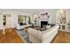 Inviting living room with fireplace, built-in shelves, and archway to a hallway. Filled with natural light at 2211 Lattimore Farm Nw Dr, Kennesaw, GA 30152