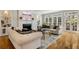 Bright living room with hardwood floors, fireplace, built-in shelving, and large windows with access to the outdoors at 2211 Lattimore Farm Nw Dr, Kennesaw, GA 30152