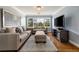 Cozy living room with hardwood floors, a large window, and comfortable neutral-toned furniture at 2211 Lattimore Farm Nw Dr, Kennesaw, GA 30152