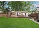 Backyard featuring a well-maintained lawn, wooden deck, and shaded seating area at 2586 Valley Stream Dr, Atlanta, GA 30360