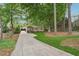 Quaint home with long driveway, mature trees, and inviting curb appeal at 2586 Valley Stream Dr, Atlanta, GA 30360