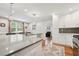Bright, open kitchen with an island, white cabinetry, hardwood floors and stainless appliances at 2586 Valley Stream Dr, Atlanta, GA 30360