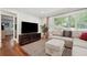 Cozy living room featuring hardwood floors, large windows, and comfortable seating at 2586 Valley Stream Dr, Atlanta, GA 30360