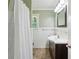 Well-lit bathroom featuring a modern vanity, neutral tones, and a shower with curtain at 261 Demetra Se Dr, Mableton, GA 30126
