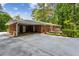 Single-story brick home with attached carport, patio and lush landscaping, offering privacy and convenience at 261 Demetra Se Dr, Mableton, GA 30126