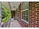 Cozy covered front porch with brick siding and white railing at 261 Demetra Se Dr, Mableton, GA 30126