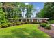 Charming brick home with manicured lawn, lush landscaping, and mature trees at 261 Demetra Se Dr, Mableton, GA 30126
