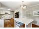 Modern kitchen with an island, stainless steel appliances, and wooden floors at 261 Demetra Se Dr, Mableton, GA 30126