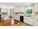 Modern kitchen with white cabinetry, stainless steel appliances, and hardwood floors at 261 Demetra Se Dr, Mableton, GA 30126