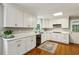 Spacious kitchen features white cabinetry, stainless appliances, and hardwood flooring at 261 Demetra Se Dr, Mableton, GA 30126