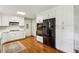 Bright kitchen with stainless steel appliances, white cabinets, and hardwood flooring at 261 Demetra Se Dr, Mableton, GA 30126