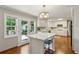 Modern kitchen featuring an island, white cabinetry, stainless steel appliances, and access to the backyard at 261 Demetra Se Dr, Mableton, GA 30126