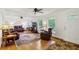 Bright living room with hardwood floors, ceiling fans, and comfortable leather furniture at 261 Demetra Se Dr, Mableton, GA 30126