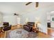 Open-concept living room with hardwood floors, ceiling fan, and access to the kitchen at 261 Demetra Se Dr, Mableton, GA 30126