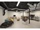 Finished basement with exposed ceiling and a variety of recreational and work areas at 283 Norton Se Cir, Smyrna, GA 30082