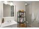 Bright bathroom featuring a white vanity, square mirror, and black shelving for storage at 283 Norton Se Cir, Smyrna, GA 30082
