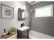 Gray tiled bathroom with a combo shower and tub and stylish mirror at 283 Norton Se Cir, Smyrna, GA 30082
