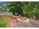 Backyard with a stone fire pit and Adirondack chairs, perfect for outdoor entertaining at 283 Norton Se Cir, Smyrna, GA 30082