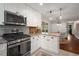 Updated kitchen features stainless steel appliances, granite countertops, white cabinets, and tile backsplash at 283 Norton Se Cir, Smyrna, GA 30082
