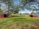 A lush backyard with mature trees and outbuildings at 4246 Chestnut Grove Ln, Austell, GA 30106