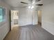 A large bedroom is bright with an open door to the bathroom, a window, and ceiling fan at 4246 Chestnut Grove Ln, Austell, GA 30106