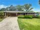 Charming brick home featuring a covered carport, well-maintained landscaping, and a classic design at 4246 Chestnut Grove Ln, Austell, GA 30106