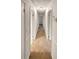 Bright hallway featuring neutral walls and carpet connects various rooms in the home at 4246 Chestnut Grove Ln, Austell, GA 30106