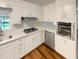 Clean, bright kitchen with white cabinets, stainless steel appliances, and wood-look flooring at 4246 Chestnut Grove Ln, Austell, GA 30106