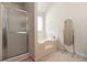 Bathroom featuring glass shower, tiled floor and a soaking tub for a luxurious spa-like experience at 6252 Selborn Sw Dr, Atlanta, GA 30331