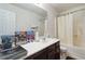 Clean bathroom featuring a tub/shower combo, vanity with a white countertop, and a mirror at 6252 Selborn Sw Dr, Atlanta, GA 30331
