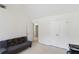 Bright bedroom with neutral carpet and walls, two large windows, and a gray futon at 6252 Selborn Sw Dr, Atlanta, GA 30331